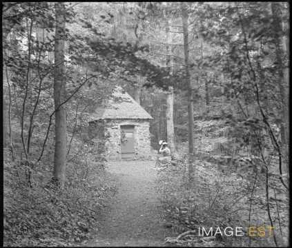 Femme devant une petite chapelle (Eulmont)