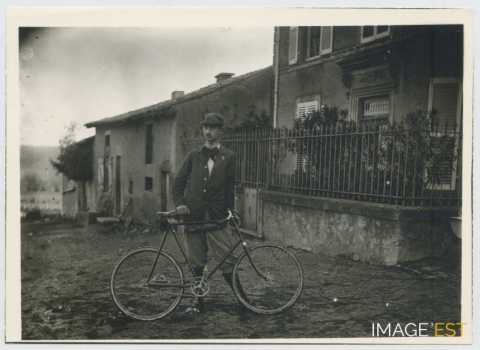 Homme tenant une bicyclette (Thumeréville)
